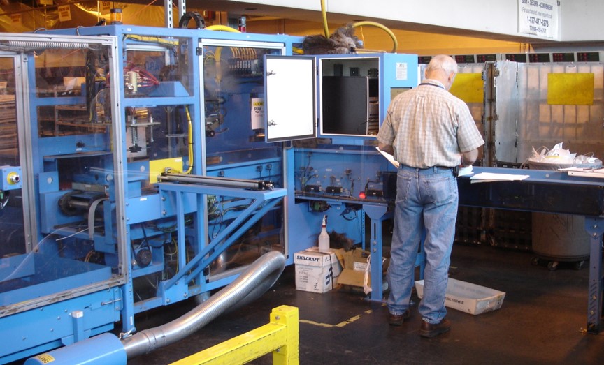 Photo of USPS techician working on sorting machine